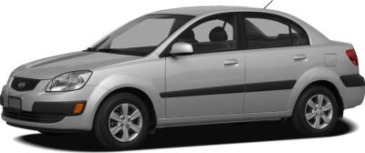 Compact four-door silver sedan with black side moldings