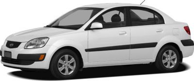 White sedan front-side view with black trim and alloy wheels