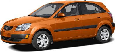 Orange compact 5-door hatchback from side front with sleek headlights