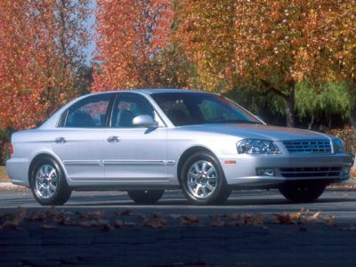 Silver sedan with chrome grille and alloy wheels in autumn setting