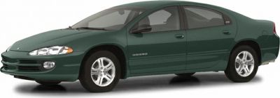 Front side view of a green sedan with distinct headlights and alloy wheels