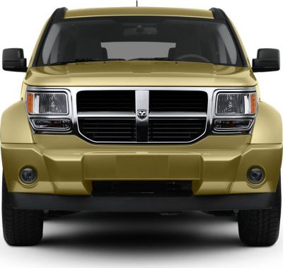 Front view with prominent grille, headlights, and rugged bumper design