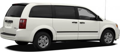 Rear-side view of white minivan with tinted windows and alloy wheels