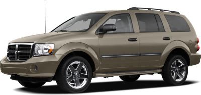 Front side view of an SUV with chrome rims and roof rails