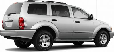 Silver SUV with rear and side view, prominent taillights and roof rails