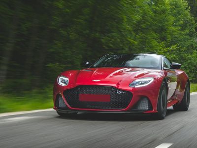 Front view of a red sports coupe with large grille and LED headlights