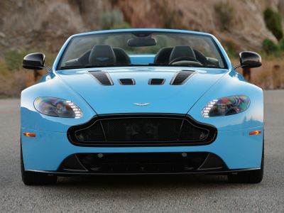 Front view of sportscar with hood vents, LED headlights, open roof convertible