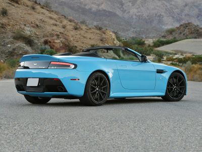 Blue convertible roadster with black multi-spoke wheels and open roof