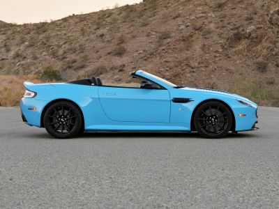 Blue convertible with black rims and aerodynamic side vents