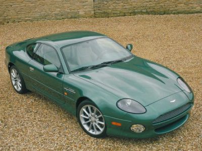 Green sports coupe with sleek aerodynamic design and distinctive front headlights