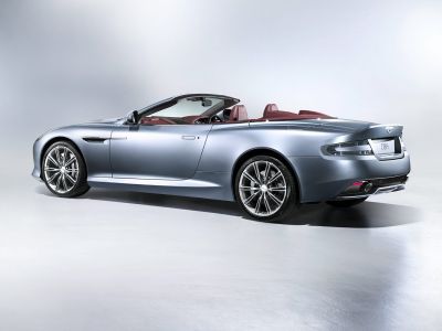 Convertible luxury sports car rear-side profile with open roof and alloy wheels