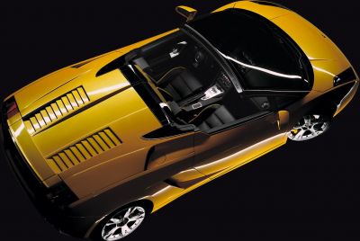 Open-top yellow sports car showcasing convertible design and interior
