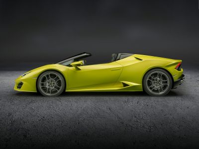 Yellow convertible sports car side profile with prominent wheels and sharp aerodynamic lines