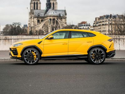 Side profile of a yellow SUV with sporty multi-spoke wheels