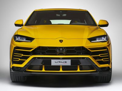 Yellow SUV front view with hexagonal grille and LED headlights