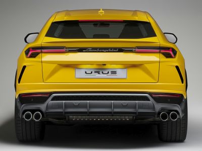 Rear view of yellow SUV with quad exhaust tips and distinctive LED taillights