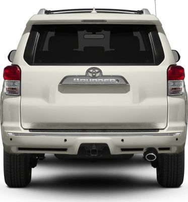 Rear view showing tailgate, taillights, and rear bumper with exhaust pipe
