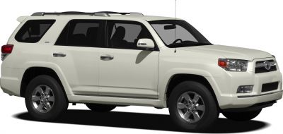 Side view of white SUV with alloy wheels and roof rails