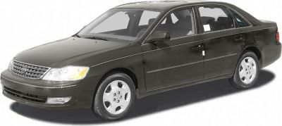 Front-side view of dark-colored mid-size sedan with detailed headlights and wheels