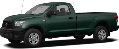 Side profile of dark green Regular Cab pickup truck with extended bed.