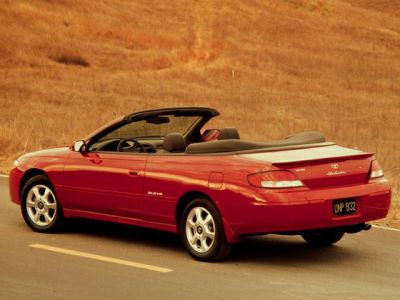 Red convertible coupe with soft top and alloy wheels