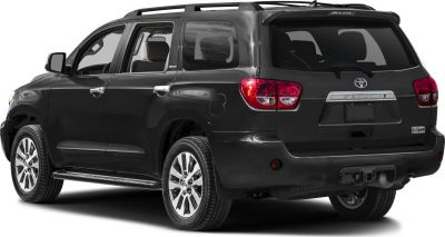 Rear side view of black SUV with tow hitch and alloy wheels