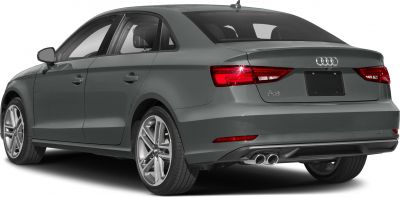 Rear side view of a grey modern sedan with dual exhaust and alloy wheels.