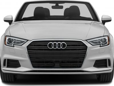 Front view of a convertible with sharp headlights and a prominent grille