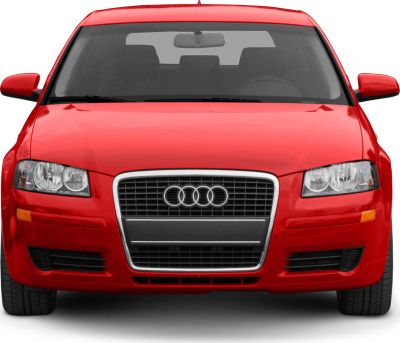 Front view of a red hatchback with grille and headlights