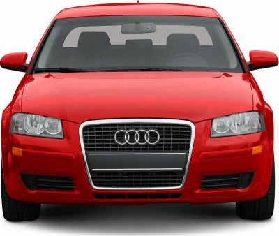 Front view showing grille and headlights of a red vehicle