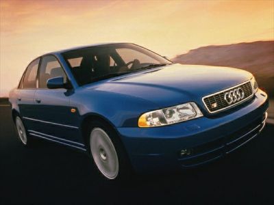 Front view of a blue sedan with classic headlights and grille.
