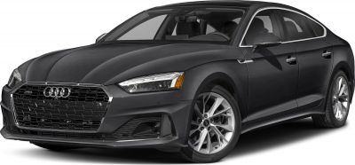 Front side view of sedan with hexagonal grille and alloy wheels