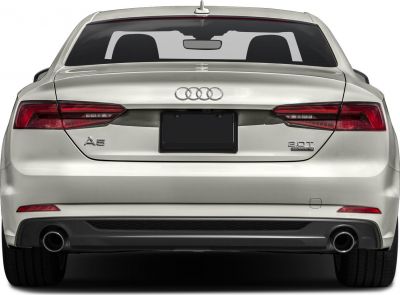 Rear view of white coupe with dual exhaust and 2.0T Quattro badge
