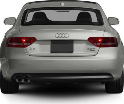 Rear of silver luxury coupe with dual exhaust and illuminated taillights