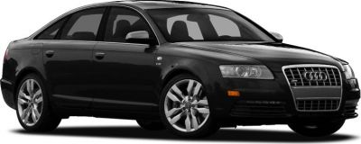 Front side view of a black sedan with distinct headlights and V8 badge.