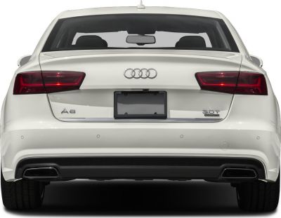 Rear view of sedan with taillights, dual exhausts, and quattro badge