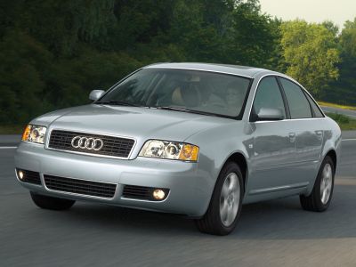 Silver sedan front three-quarter view with headlights and side mirrors