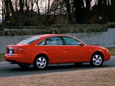 Red sedan with alloy wheels, side and rear profile