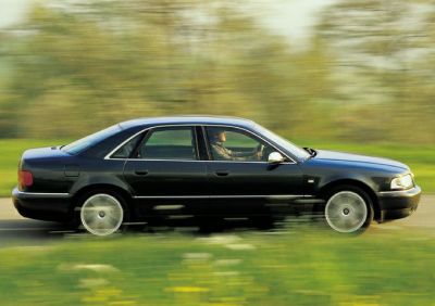 Side profile of full-size luxury sedan with motion blur effect