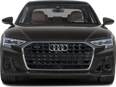 Close-up of large hexagonal grille and LED headlights on a luxury sedan front.