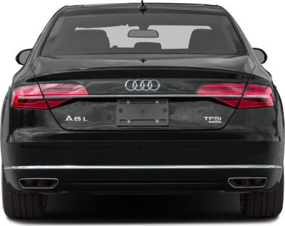 Rear of a luxury sedan with LED tail lights and dual exhausts
