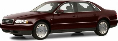 Side view of a luxury sedan with classic alloy wheels and four doors.