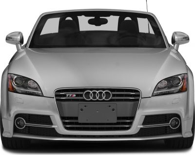 Close-up front view of sporty convertible with distinctive grille and headlights.