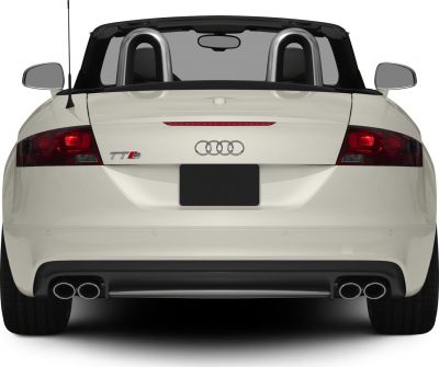 Rear view of a convertible with quad exhaust tips and roll bars.