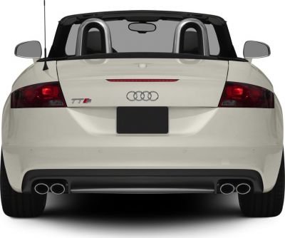 Rear view of white convertible with dual exhaust and sporty taillights.