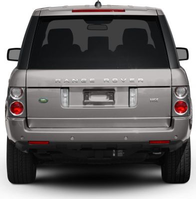 Rear view showing tail lights, badges, rear window, and tailgate of SUV.
