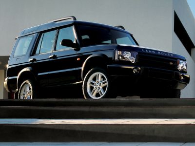 Front and side view of black SUV with rugged design and alloy wheels