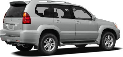 Rear-side profile of a mid-2000s luxury SUV with V8 engine badge and roof rails