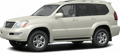 Side view of mid-2000s white SUV with alloy wheels