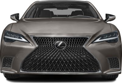 Large intricate spindle grille with sleek LED headlights on sedan front.
